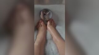 BBW splashes her adorable foot into the bathtub.