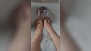 BBW splashes her adorable foot into the bathtub.