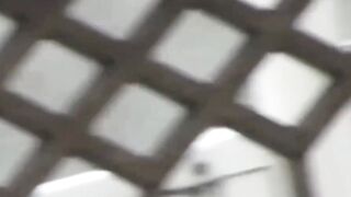 Peeping lens films girls urinating in open public toilets