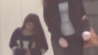 Peeping lens films girls urinating in open public toilets