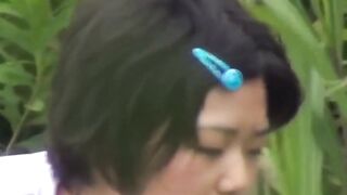 Japanese vixen strokes her bushy slit while outdoor piss