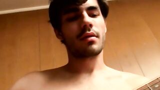 Handsome guy plays guitar while jerking off alone