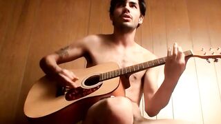 Handsome guy plays guitar while jerking off alone