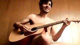 Handsome guy plays guitar while jerking off alone