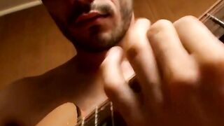 Handsome guy plays guitar while jerking off alone