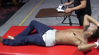 Kaden Roads slaps captive with flogger before jerking his cock