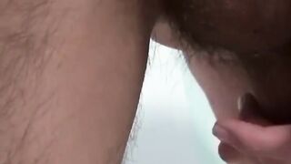 Young Japanese spreads ass while stroking cock