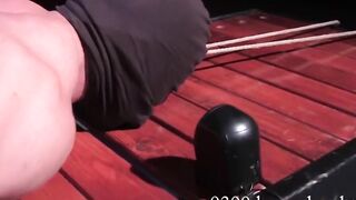 Tyler Saint roped to table with cock clamped by heavy weight