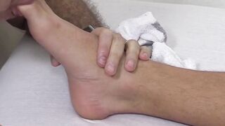 Sleeping hunk unaware of toe sucking intruder
