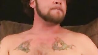 Tattooed stud relaxes before jerking to cumshot