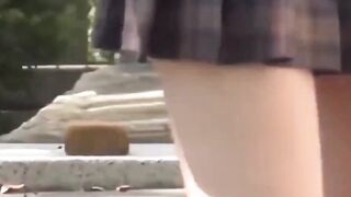 Sporty Japanese babe filmed playing in a tiny short skirt