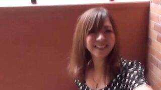 Cameraman hands her juice bottle as she seeks a spot to pee