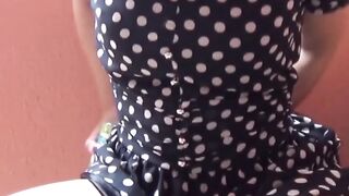 Cameraman hands her juice bottle as she seeks a spot to pee