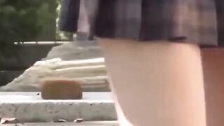 Athletic Japanese girl filmed during play in short skirt
