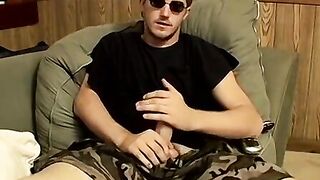 Handsome dude strokes firm cock to completion