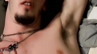 Guitar player strums while stroking hairy cock