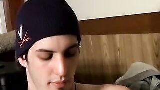 Guitar player strums while stroking hairy cock