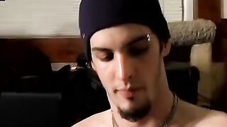 Guitar player strums while stroking hairy cock