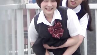 On quiet rooftop pair of student teens share joint pee break