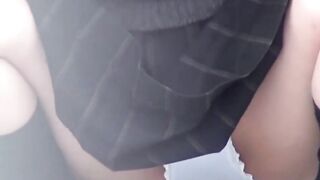 On quiet rooftop pair of student teens share joint pee break