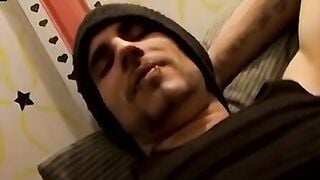 Tattooed dude puffs cigars while jerking slowly