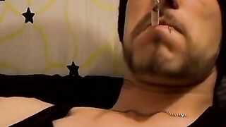 Tattooed dude puffs cigars while jerking slowly