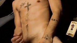 Tattooed dude puffs cigars while jerking slowly