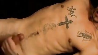 Tattooed dude puffs cigars while jerking slowly