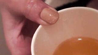Japanese babes golden stream fills the container on camera