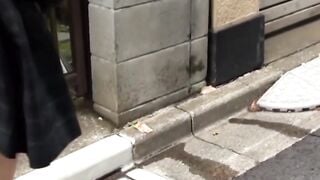 Japanese schoolgirl pisses her panties while walking down the streets
