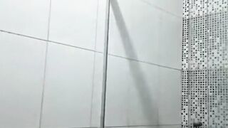 Twink David Scott jams his cock in the bathroom while watching porn