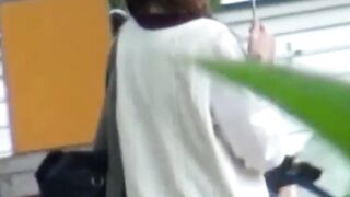 Rain didnt stop this Asian cutie from fingering her twat outdoors