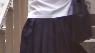 Japanese teens sit on steps and show damp pink panties to the camera