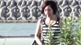 Voyeur films Asian women making puddles ina  public park