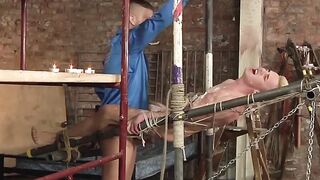 Blond sub restrained for painful hot wax body art