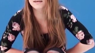 Asian amateur girl peeing in shorts during solo photoshoot