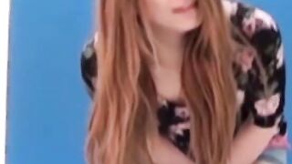 Asian amateur girl peeing in shorts during solo photoshoot