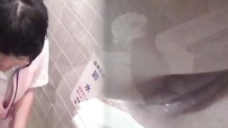 Asian office gals crouch to dump golden flow into toilet bowl