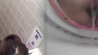 Asian office gals crouch to dump golden flow into toilet bowl