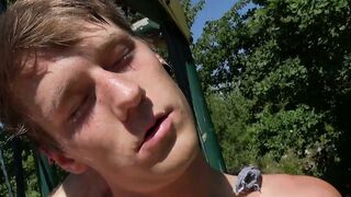 Muscular blond twink workouts on playground pull-up bars and shows his dick