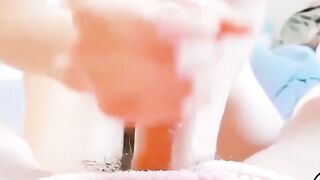 Close-Up Handjob on Pink Towel with Smooth Skin and Dark Pubes