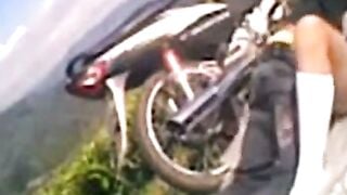 Blonde Woman in Blue Bikini Riding a Motorcycle Outdoors