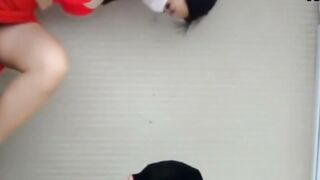 Red Outfit Woman in High Heels Bends Over for Man in Black Cap