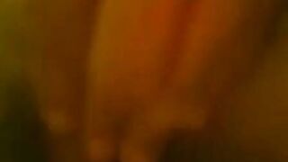 Close-up of a hand pulling down green underwear to reveal bare skin