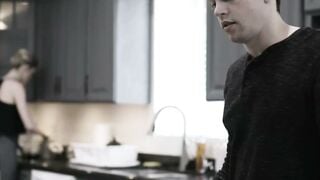 Blonde Maid Cleaning Kitchen in Black Top with Man