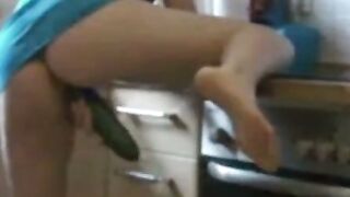 German Amateur Girl Sucks Large Cucumber in Kitchen