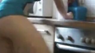 German Amateur Girl Sucks Large Cucumber in Kitchen