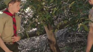 Scout boy bound up against a tree inside the woods by 2 mature scout boys