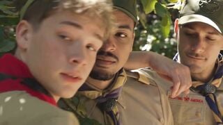 Scout boy bound up against a tree inside the woods by 2 mature scout boys