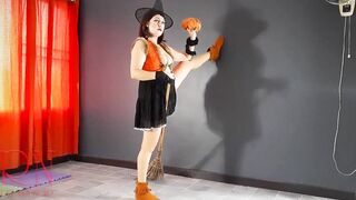 HALLOWEEN 2021 Witch inside a beauty red suit. Red-haired witch with pumpkins and a broom. Regina Noir